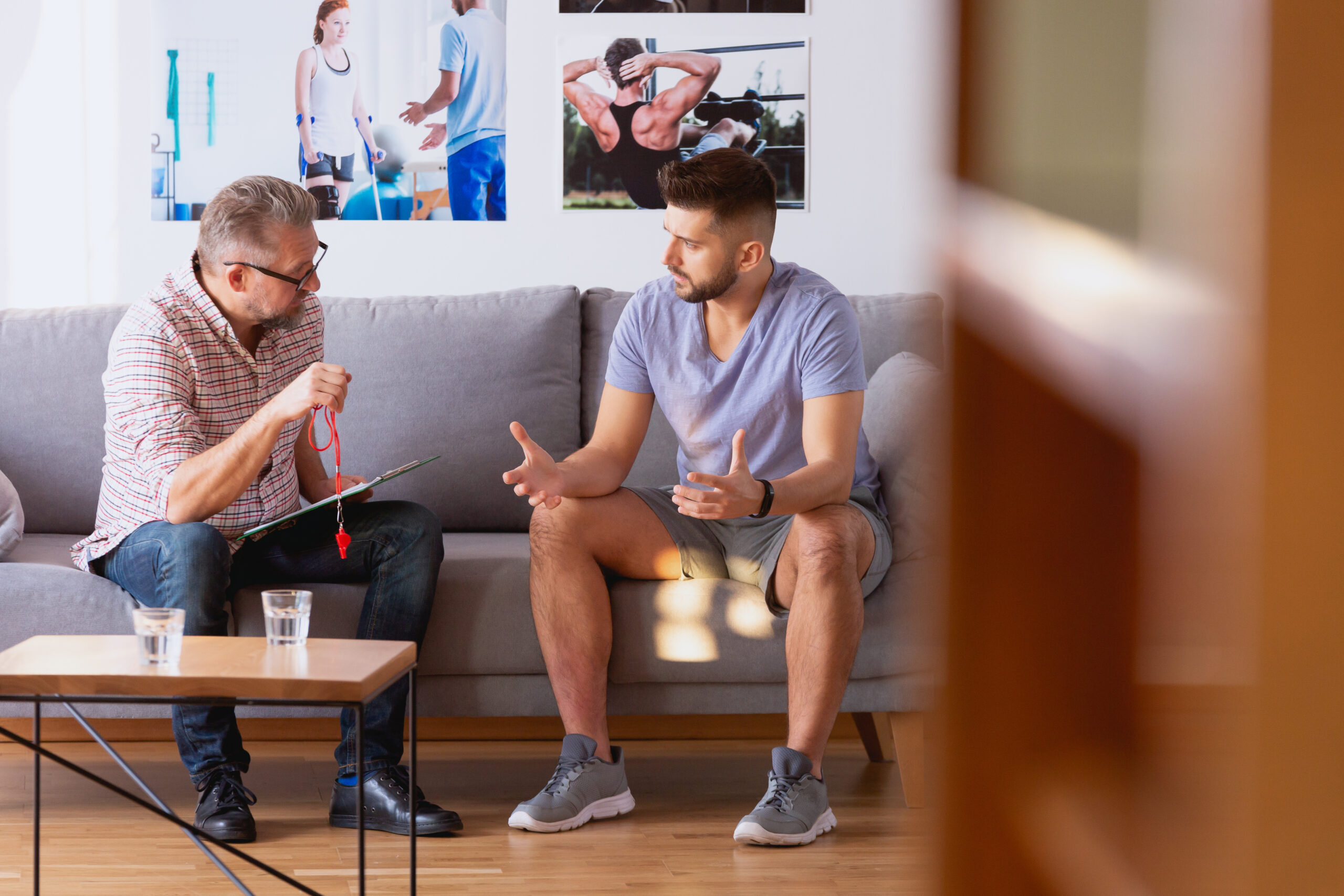 Young man talking with a coach about his diet